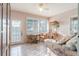 Relaxing sunroom with tile floors, wicker furniture, and a large window providing ample natural light at 2801 Gulf Blvd, Belleair Beach, FL 33786