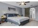 Cozy bedroom featuring modern decor, neutral gray walls, and a sliding barn door entrance at 30317 Rattana Ct, Wesley Chapel, FL 33545