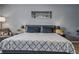 Serene bedroom with a bridge-view wall art, neutral tones, and a cozy seating area at 30317 Rattana Ct, Wesley Chapel, FL 33545