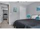 Bedroom featuring neutral decor, a queen bed with grey bedding and art on the walls at 30317 Rattana Ct, Wesley Chapel, FL 33545