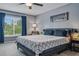 Bright bedroom with a large window, stylish bedding, and a comfortable sitting area at 30317 Rattana Ct, Wesley Chapel, FL 33545