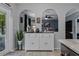 Stylish coffee bar with elegant arches, decorative accents, and ample storage space at 30317 Rattana Ct, Wesley Chapel, FL 33545