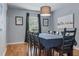 Inviting dining room featuring hardwood floors, contemporary lighting, and stylish decor at 30317 Rattana Ct, Wesley Chapel, FL 33545