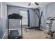 Home exercise room featuring a treadmill and Bowflex workout machine at 30317 Rattana Ct, Wesley Chapel, FL 33545