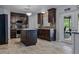 Well-appointed kitchen with a center island, stainless steel appliances, and access to outdoor living space at 30317 Rattana Ct, Wesley Chapel, FL 33545