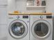 Bright laundry room featuring side-by-side LG washer and dryer, plus storage space at 30317 Rattana Ct, Wesley Chapel, FL 33545