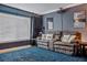 Cozy living room with plush blue carpet, neutral gray walls, and a comfortable seating area at 30317 Rattana Ct, Wesley Chapel, FL 33545
