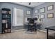 Home office with bookshelf, desk setup, neutral carpet, and natural light at 30317 Rattana Ct, Wesley Chapel, FL 33545