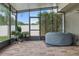 Screened-in patio featuring a brick floor, privacy lattice and a covered hot tub at 30317 Rattana Ct, Wesley Chapel, FL 33545