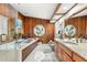 Spacious bathroom featuring granite countertops, wooden cabinets and a separate tub with a glass shower at 3133 Harvest Moon Dr, Palm Harbor, FL 34683