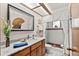 Bathroom vanity with marble countertop, a decorative mirror, and a separate shower space at 3133 Harvest Moon Dr, Palm Harbor, FL 34683