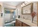 Well-maintained bathroom featuring a vanity with wooden cabinets, a shower with glass doors, and classic fixtures at 3133 Harvest Moon Dr, Palm Harbor, FL 34683