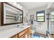 Bright bathroom featuring a granite countertop vanity and shower-tub combo at 3133 Harvest Moon Dr, Palm Harbor, FL 34683