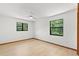 Bright and airy bedroom with light-colored floors and two windows offering plenty of natural light at 3133 Harvest Moon Dr, Palm Harbor, FL 34683