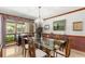 Elegant dining room with large window, patterned wallpaper, and stylish furnishings at 3133 Harvest Moon Dr, Palm Harbor, FL 34683
