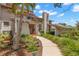 Beautiful home exterior with a well-manicured lawn, mature landscaping and a unique architectural design at 3133 Harvest Moon Dr, Palm Harbor, FL 34683