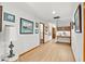 Hallway featuring wood floors, decorative art, and a built-in desk area at 3133 Harvest Moon Dr, Palm Harbor, FL 34683