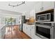 Well-lit kitchen with stainless steel appliances and views of the pool and outdoor dining area at 3133 Harvest Moon Dr, Palm Harbor, FL 34683