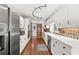 Long galley kitchen with stainless steel appliances and ample cabinet space at 3133 Harvest Moon Dr, Palm Harbor, FL 34683