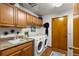 Functional laundry room with cabinets, utility sink, and modern washer and dryer at 3133 Harvest Moon Dr, Palm Harbor, FL 34683