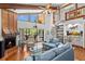 Cozy living room featuring fireplace, spiral staircase, beamed ceilings, and patio access at 3133 Harvest Moon Dr, Palm Harbor, FL 34683