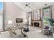 Bright living room featuring a fireplace, plush sofas, and high ceilings with natural light at 3133 Harvest Moon Dr, Palm Harbor, FL 34683