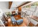 An aerial view of an elegant living room with spiral staircase, a fireplace and beamed ceilings at 3133 Harvest Moon Dr, Palm Harbor, FL 34683