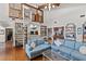 Living room with hardwood floors, a spiral staircase, high ceilings, and a cozy bar area at 3133 Harvest Moon Dr, Palm Harbor, FL 34683