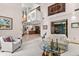 Open-concept living area with high ceilings, a fireplace, and stylish decor, perfect for modern living at 3133 Harvest Moon Dr, Palm Harbor, FL 34683