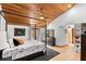Spacious main bedroom with a four-poster bed, wood ceiling, and access to a private balcony at 3133 Harvest Moon Dr, Palm Harbor, FL 34683