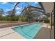 Relaxing enclosed pool with clear blue water and a large patio area for lounging and recreation at 3133 Harvest Moon Dr, Palm Harbor, FL 34683