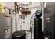 Utility room featuring a water heater, water softener, and other essential systems at 3133 Harvest Moon Dr, Palm Harbor, FL 34683