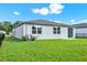New home featuring sliding glass door and fenced backyard with lush green grass at 3146 Forrest Plum Ct, Zephyrhills, FL 33540