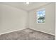 Carpeted bedroom with natural light coming in through the window at 3146 Forrest Plum Ct, Zephyrhills, FL 33540