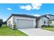 Single-story home with a clean facade, attached garage, and a neatly landscaped front yard at 3146 Forrest Plum Ct, Zephyrhills, FL 33540