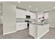 Modern kitchen with white cabinetry, granite countertops, a center island, and stainless steel appliances at 3146 Forrest Plum Ct, Zephyrhills, FL 33540