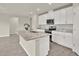 Bright kitchen with white cabinets, stainless steel appliances, granite counters and a center island at 3146 Forrest Plum Ct, Zephyrhills, FL 33540