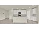 Clean kitchen with white cabinets, stainless steel appliances, an island with sink and granite countertops at 3146 Forrest Plum Ct, Zephyrhills, FL 33540