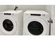 Laundry room with side-by-side white Whirlpool washing machine and dryer at 3146 Forrest Plum Ct, Zephyrhills, FL 33540