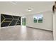 Spacious living room featuring neutral walls, sliding glass door access to the backyard, and wood flooring at 3146 Forrest Plum Ct, Zephyrhills, FL 33540