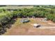 Expansive aerial view of the property, highlighting the home's placement amongst mature trees and structures at 3147 Sydney Dover Rd, Dover, FL 33527