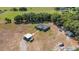Aerial view of the property showcasing the home, surrounding acreage and covered parking at 3147 Sydney Dover Rd, Dover, FL 33527