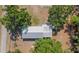 Aerial view showcasing the home's roof, surrounding trees, and lush green yard at 3147 Sydney Dover Rd, Dover, FL 33527