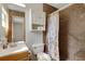 Bathroom featuring tiled shower, grab bar, built-in shelves, and a vanity sink at 3147 Sydney Dover Rd, Dover, FL 33527