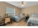 Charming bedroom with two beds, soft natural light, and wood-look flooring at 3147 Sydney Dover Rd, Dover, FL 33527