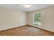 Bedroom showcasing neutral walls, carpet, and a window that provides natural light, creating a serene atmosphere at 3147 Sydney Dover Rd, Dover, FL 33527