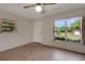 Bright bedroom featuring tile flooring, natural light, and a view of the outdoors at 3147 Sydney Dover Rd, Dover, FL 33527