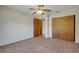 Bedroom features a double door closet, ceiling fan, and neutral carpet flooring at 3147 Sydney Dover Rd, Dover, FL 33527