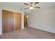 Bedroom featuring a double door closet, ceiling fan, and neutral carpet flooring at 3147 Sydney Dover Rd, Dover, FL 33527