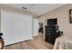 Neutral bedroom with wood floors, wardrobe, ceiling fan, and tv atop the dresser at 3147 Sydney Dover Rd, Dover, FL 33527
